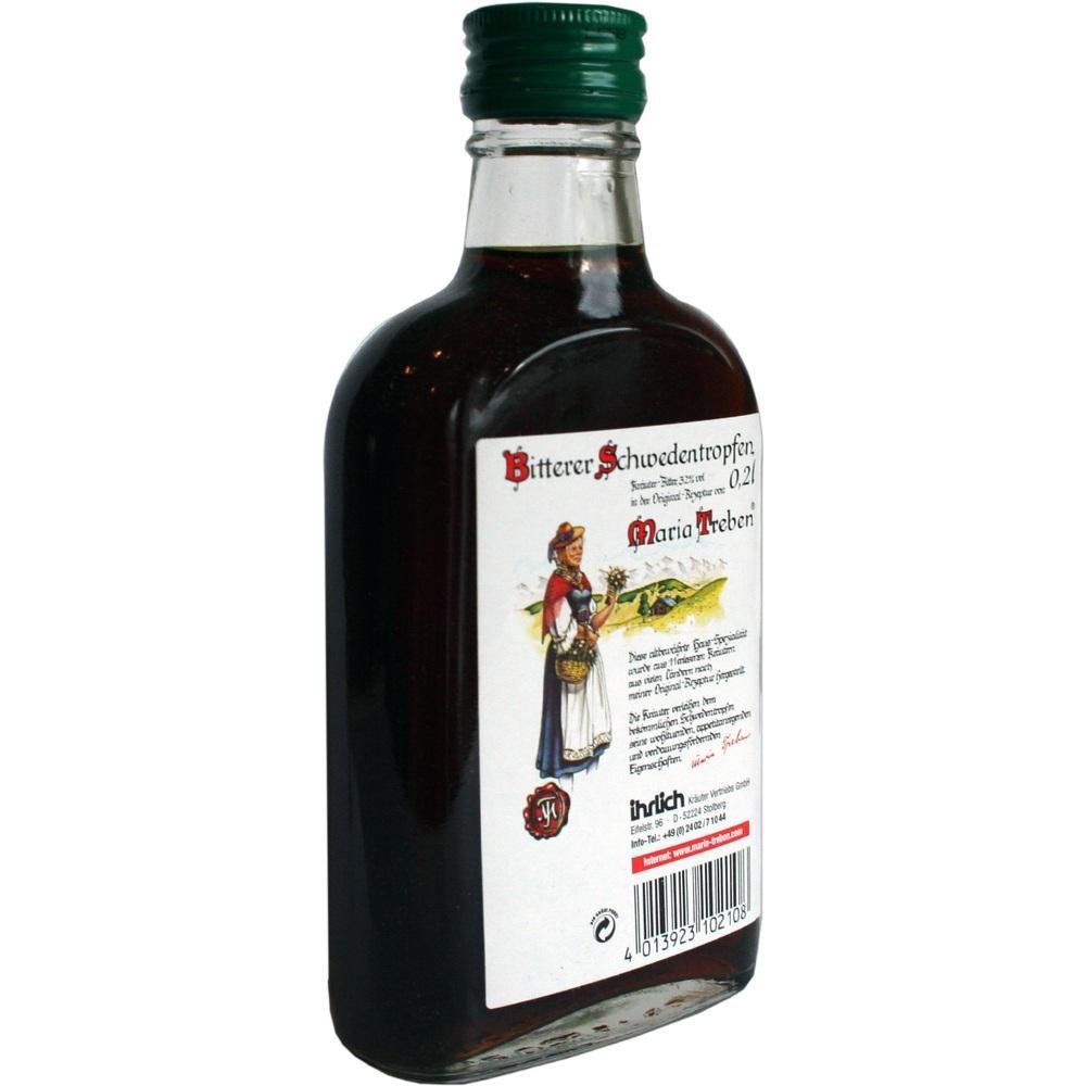 Flasche mit bitterem Schwedenkraut und Etikett, auf dem eine Frau in traditioneller Kleidung abgebildet ist.