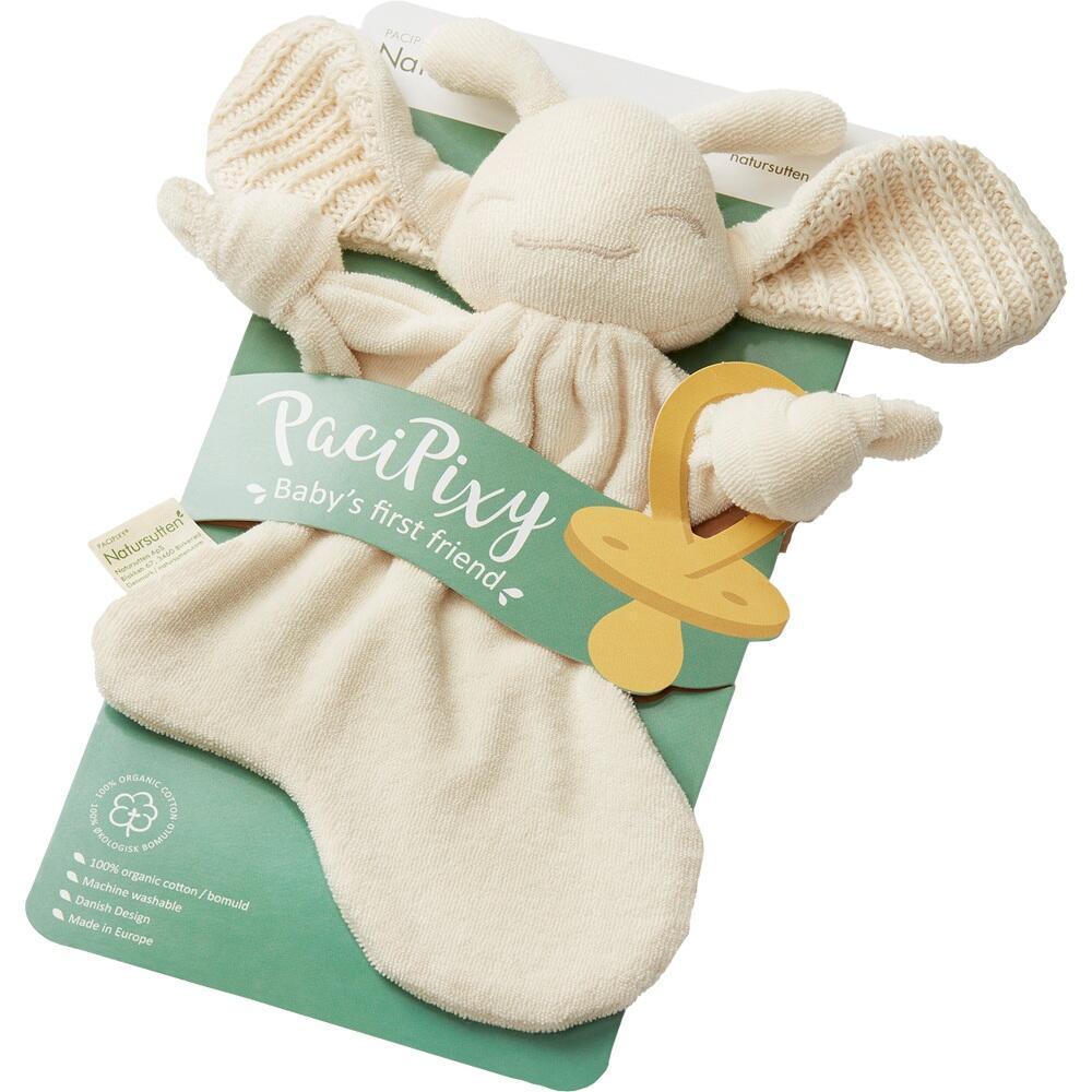 Ein weiches Kuscheltier mit Fl&uuml;geln auf einem gr&uuml;nen Pappkarton.