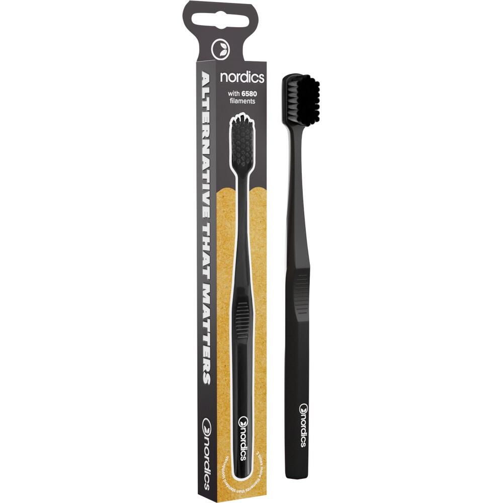 Eine schwarze Zahnb&uuml;rste neben ihrer Verpackung.