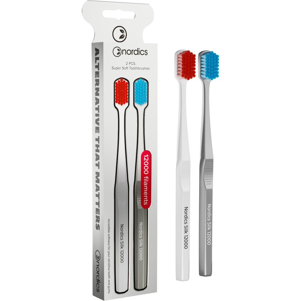 Zwei weiche Zahnb&uuml;rsten, rot und blau, neben ihrer Verpackung.