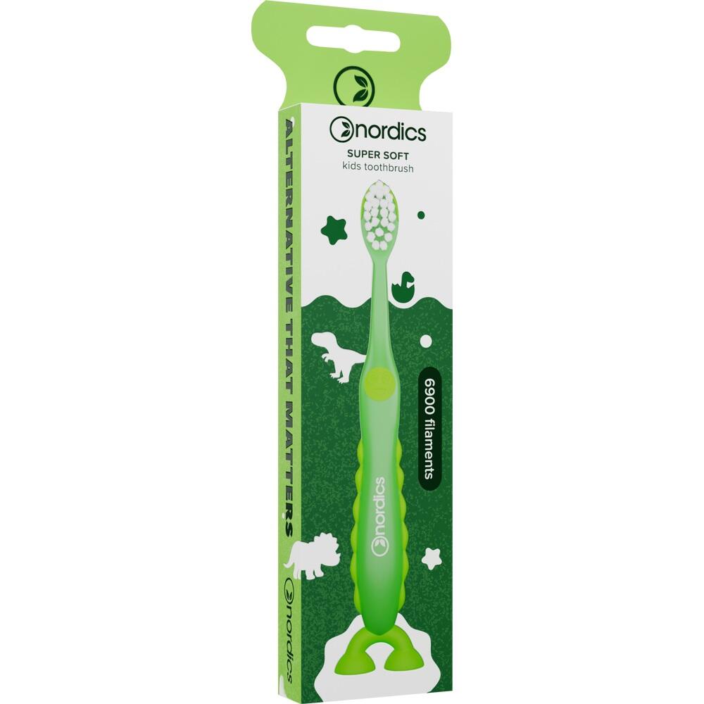 Grüne Kinderzahnbürste mit Dino-Motiven auf der Verpackung.